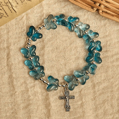 Bransoletka modlitewna z motywem zwierząt i mieniącym się niebieskim motylem Wings of Devotion